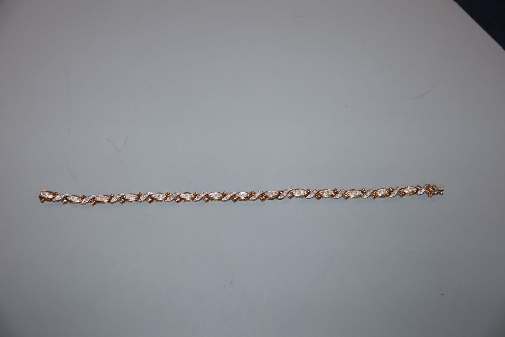 A modern 375 yellow metal and diamond chip set line bracelet, 18.9cm, gross 7.4 grams.